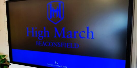 High March logo is displayed on a Vivi connected display in a classroom.