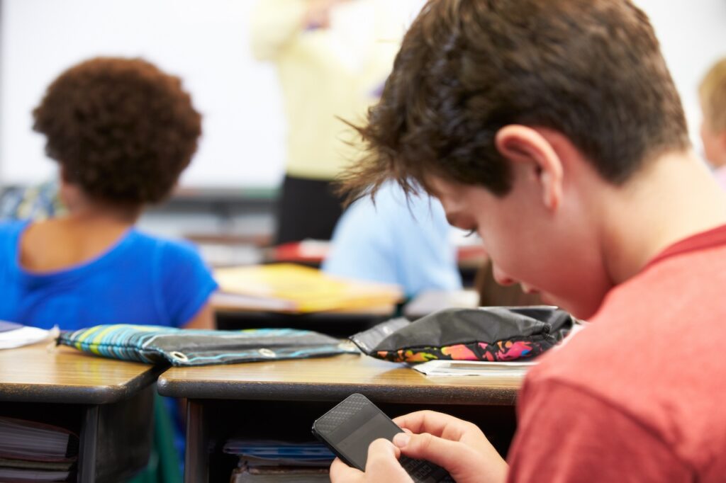 a boy using a cell phone