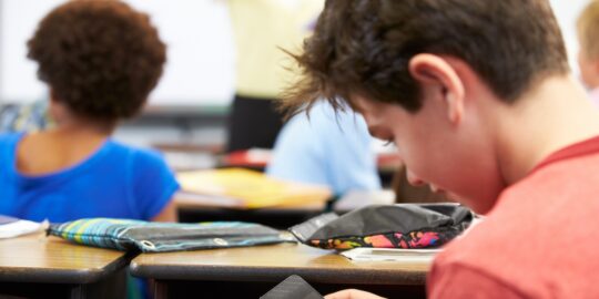 a boy using a cell phone