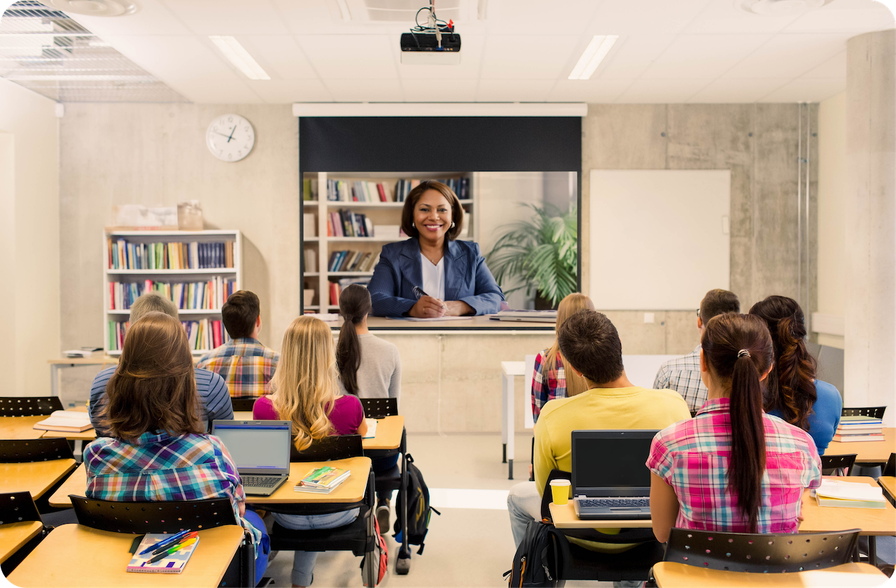 a woman in a classroom with a group of students