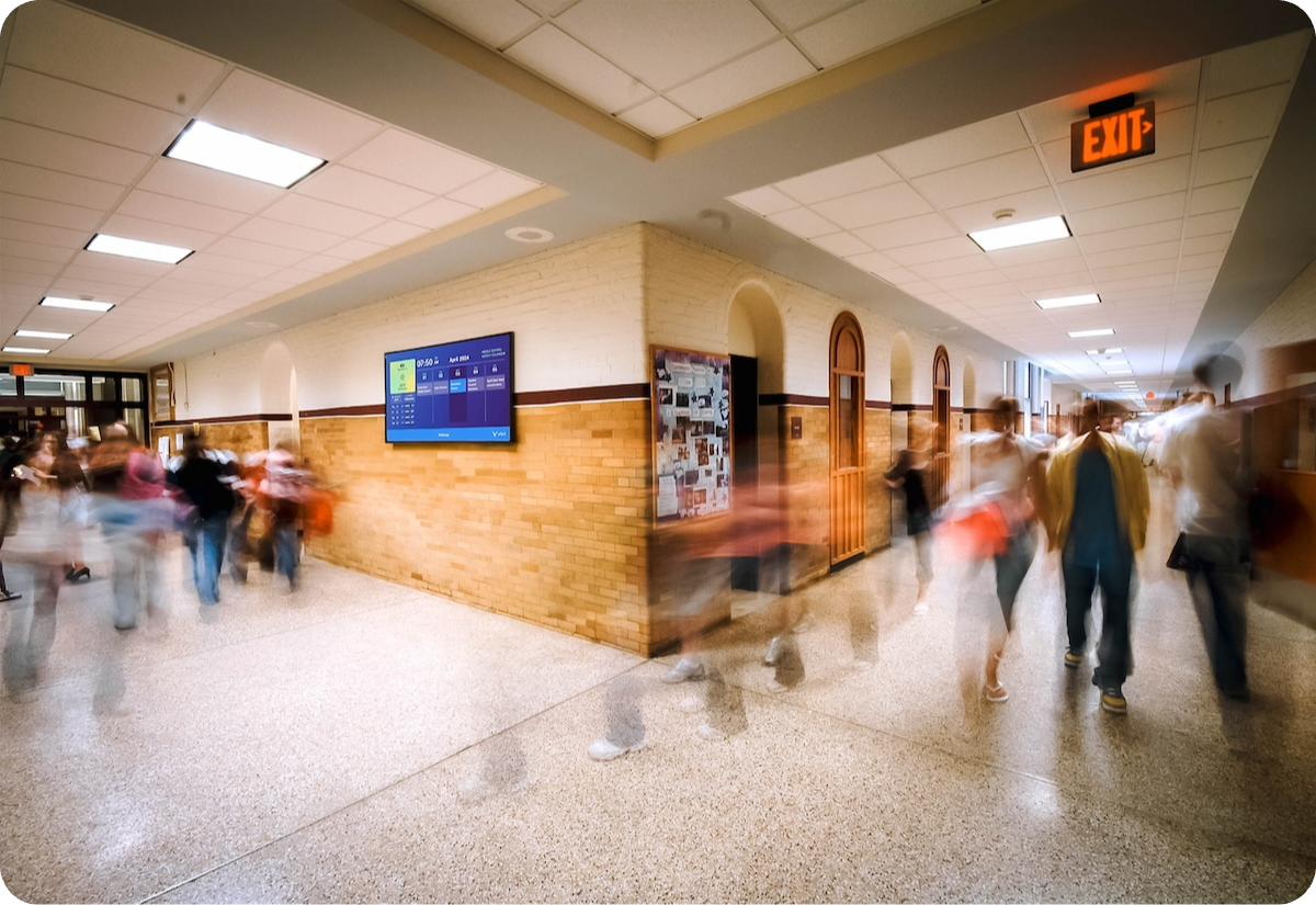 a group of people walking in a hallway