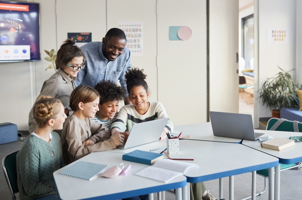 Group of Kids Looking at Computer Screen in School